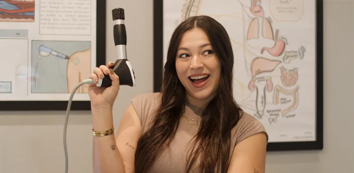 Dr. Maria Medina holding a shockwave therapy device