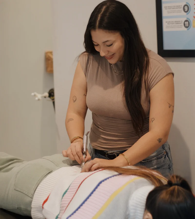 Dr. Maria Medina adjusting a patient's back